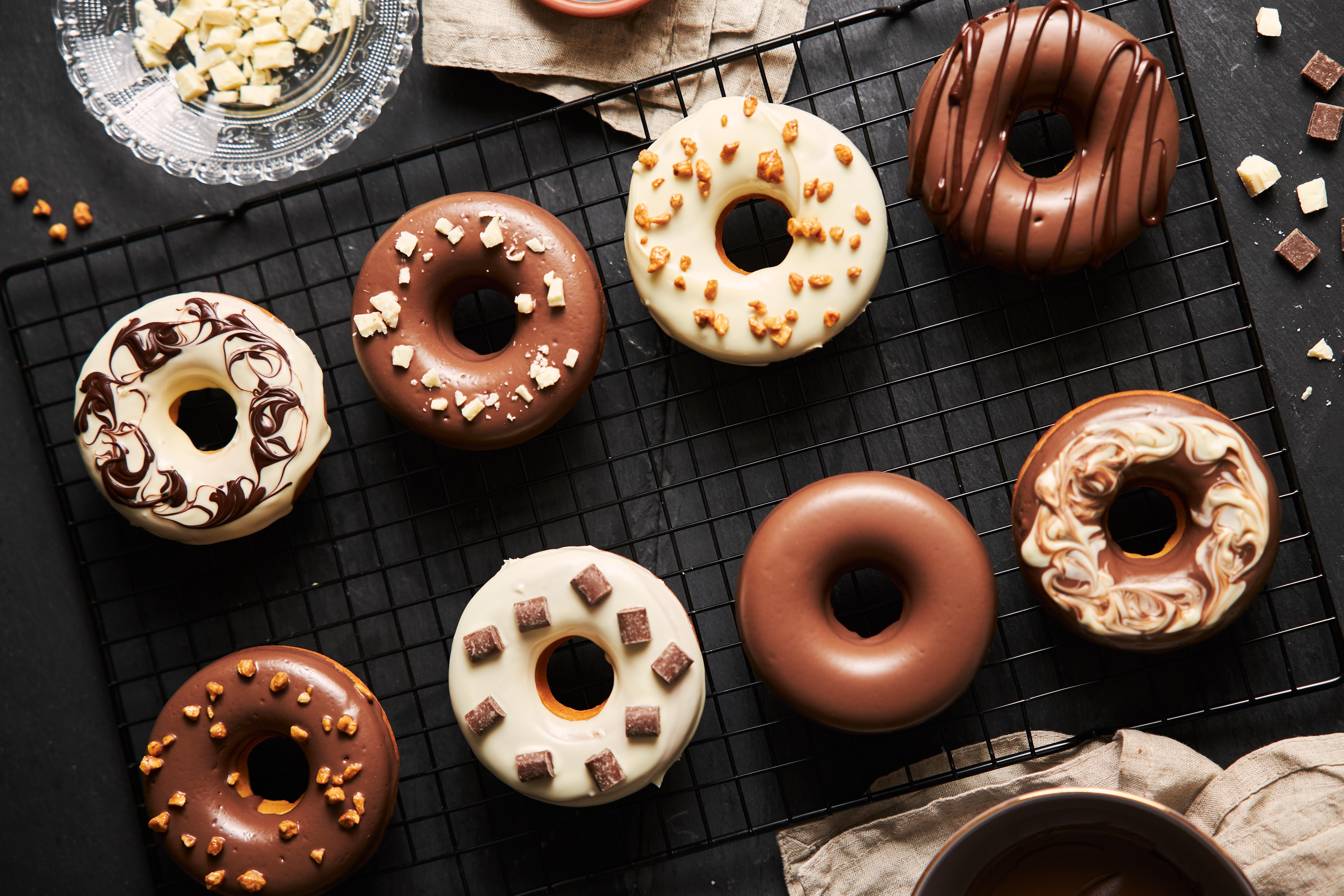 Various donuts glazed in white and milk chocolate